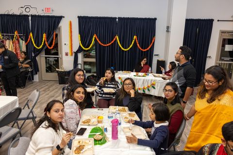 Guests seated and sharing a meal together at Poush Parbon 2026