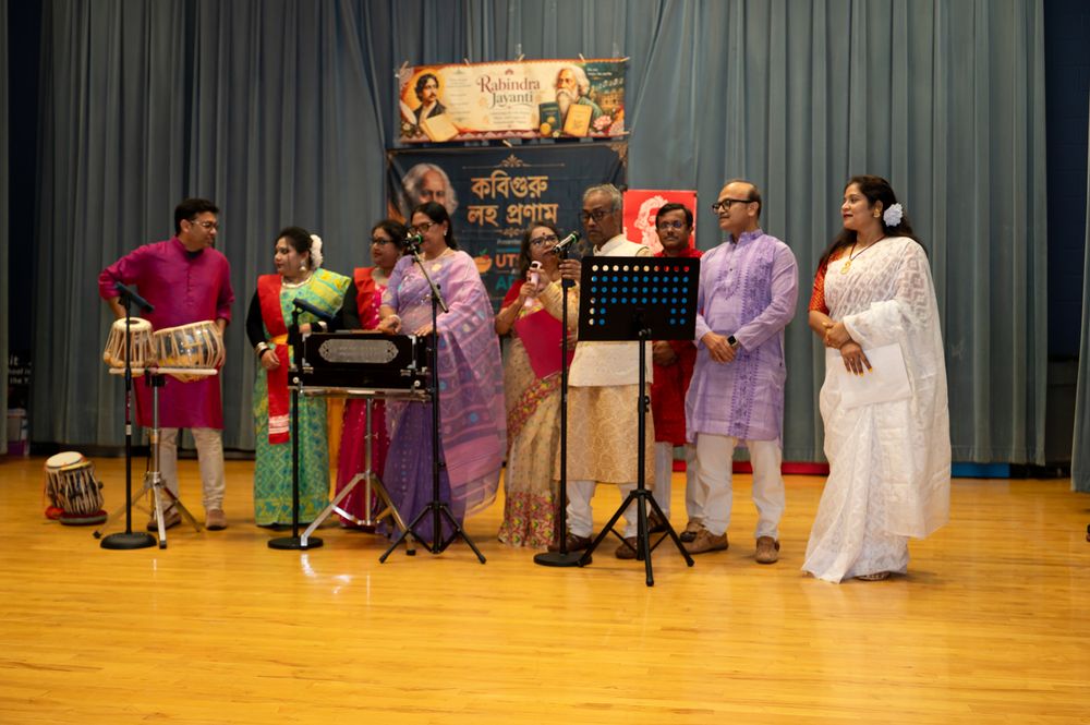 Singers performing Rabindra Sangeet on stage at an Utsav & Adda cultural program